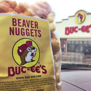 A picture of a bag of beaver nuggets in front of the Buc-ee's building.