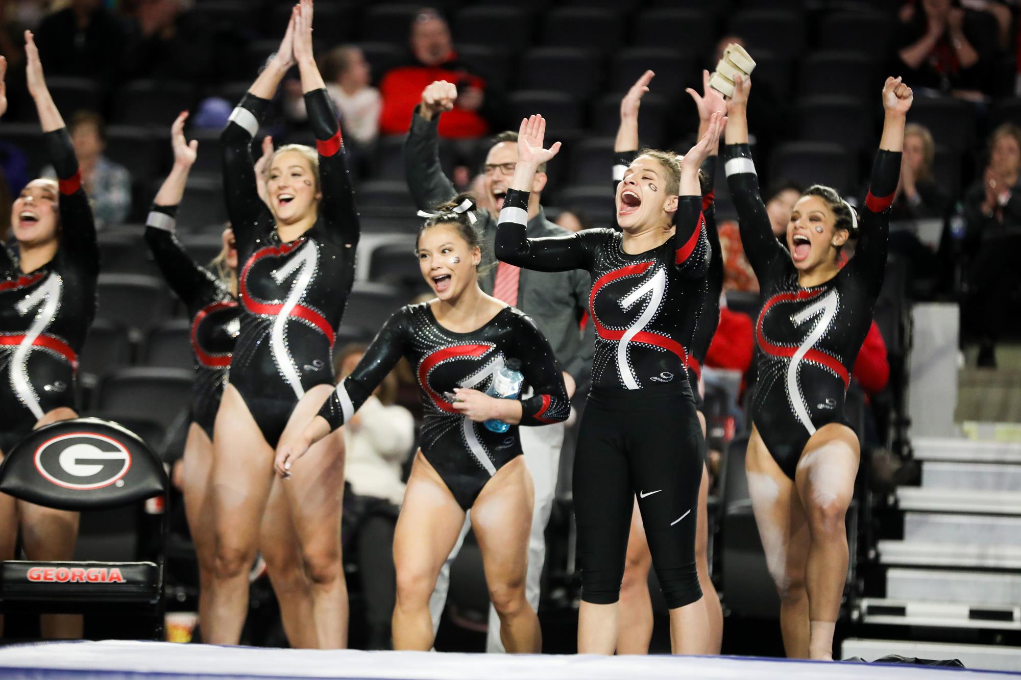 A picture of six gymnasts cheering.