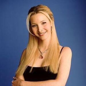 A headshot of a woman (Lisa Kudrow) wearing a black tank top with her arms crossed.